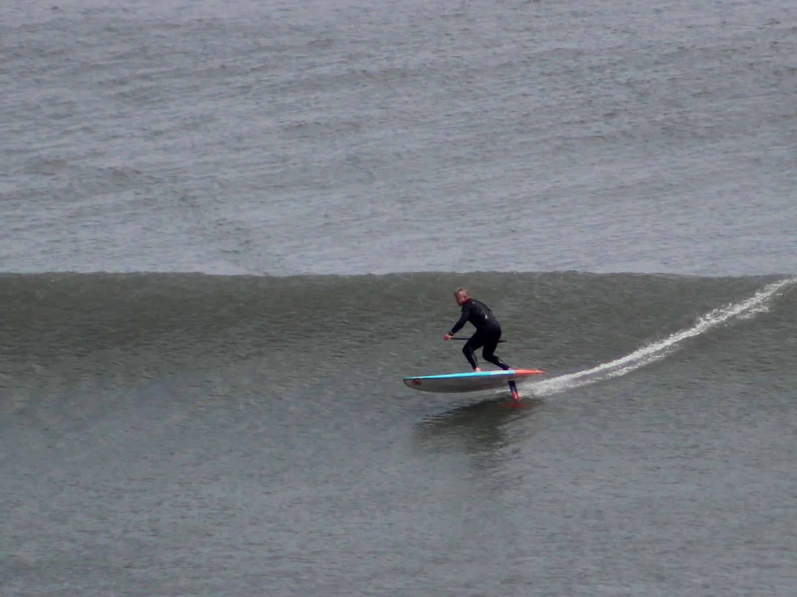 Miguel Lunceford SUP foiling along a wave at Chicama.