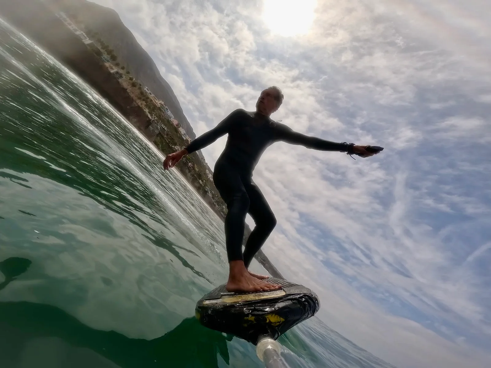 Ted Robinson foiling on a wave from a close on-board camera angle.
